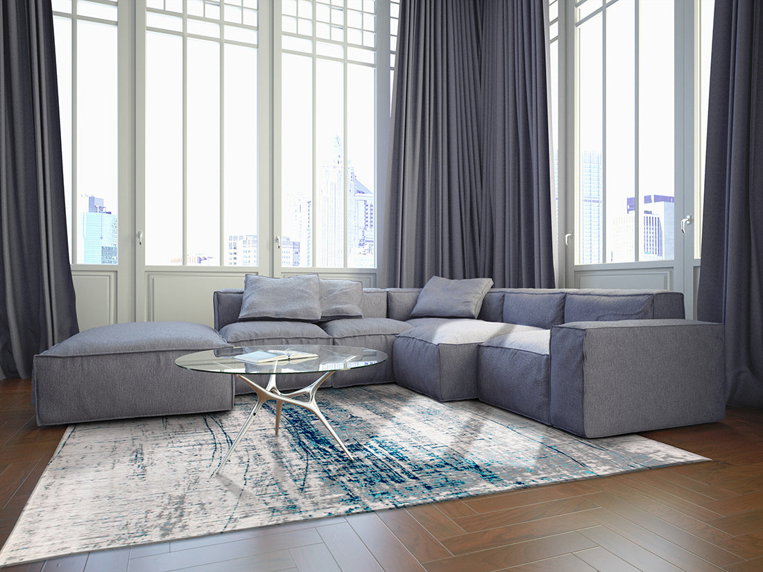 White flatweave rug with grey and blue abstract pattern