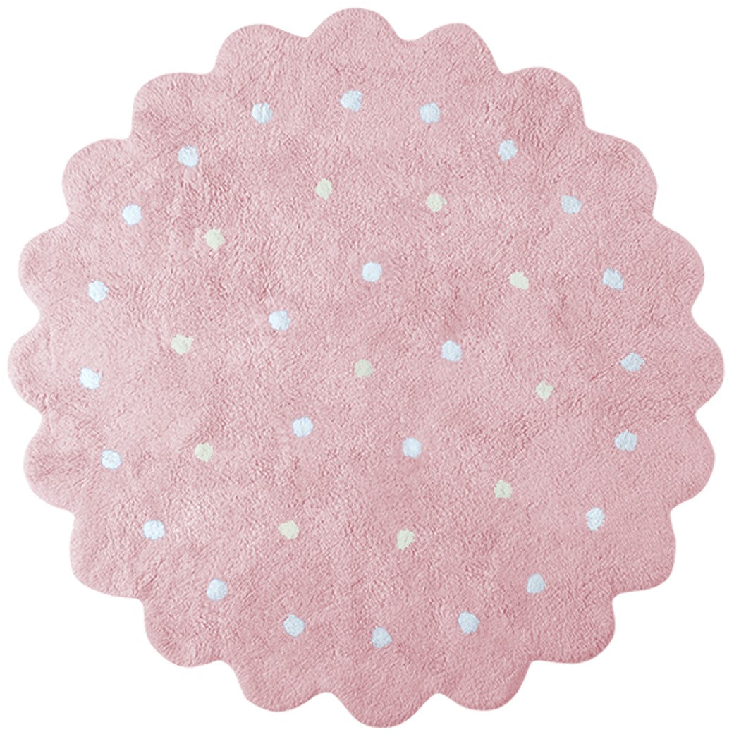 Circular pink rug with scalloped edge and white polka dot design