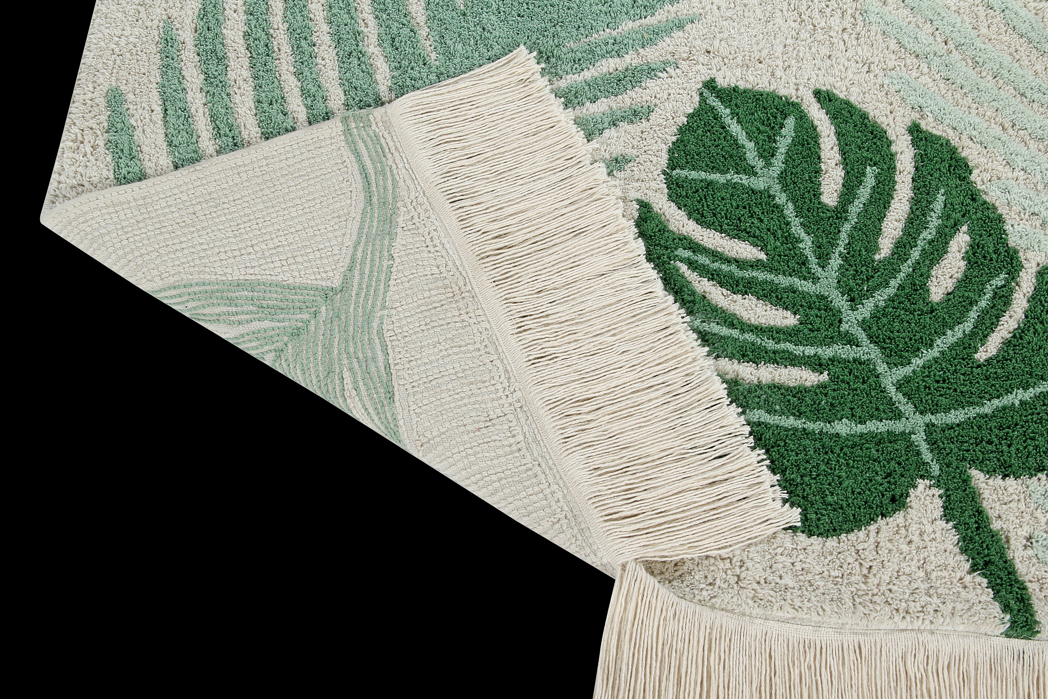 Rectangular beige cotton rug decorated with large green leaves and a fringed border