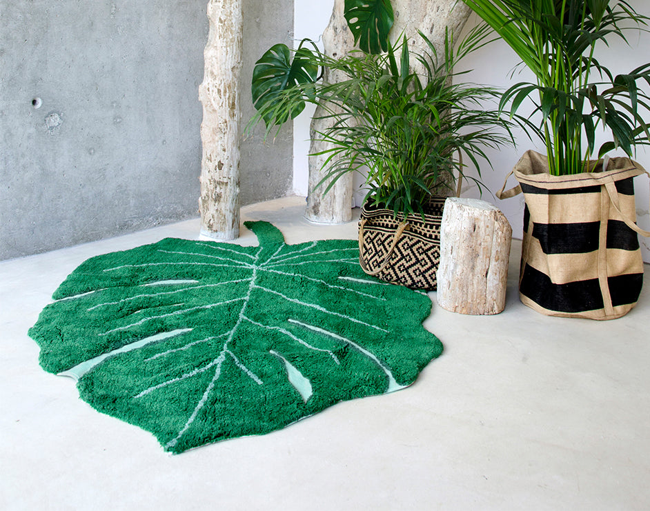 A large green leaf-shaped rug