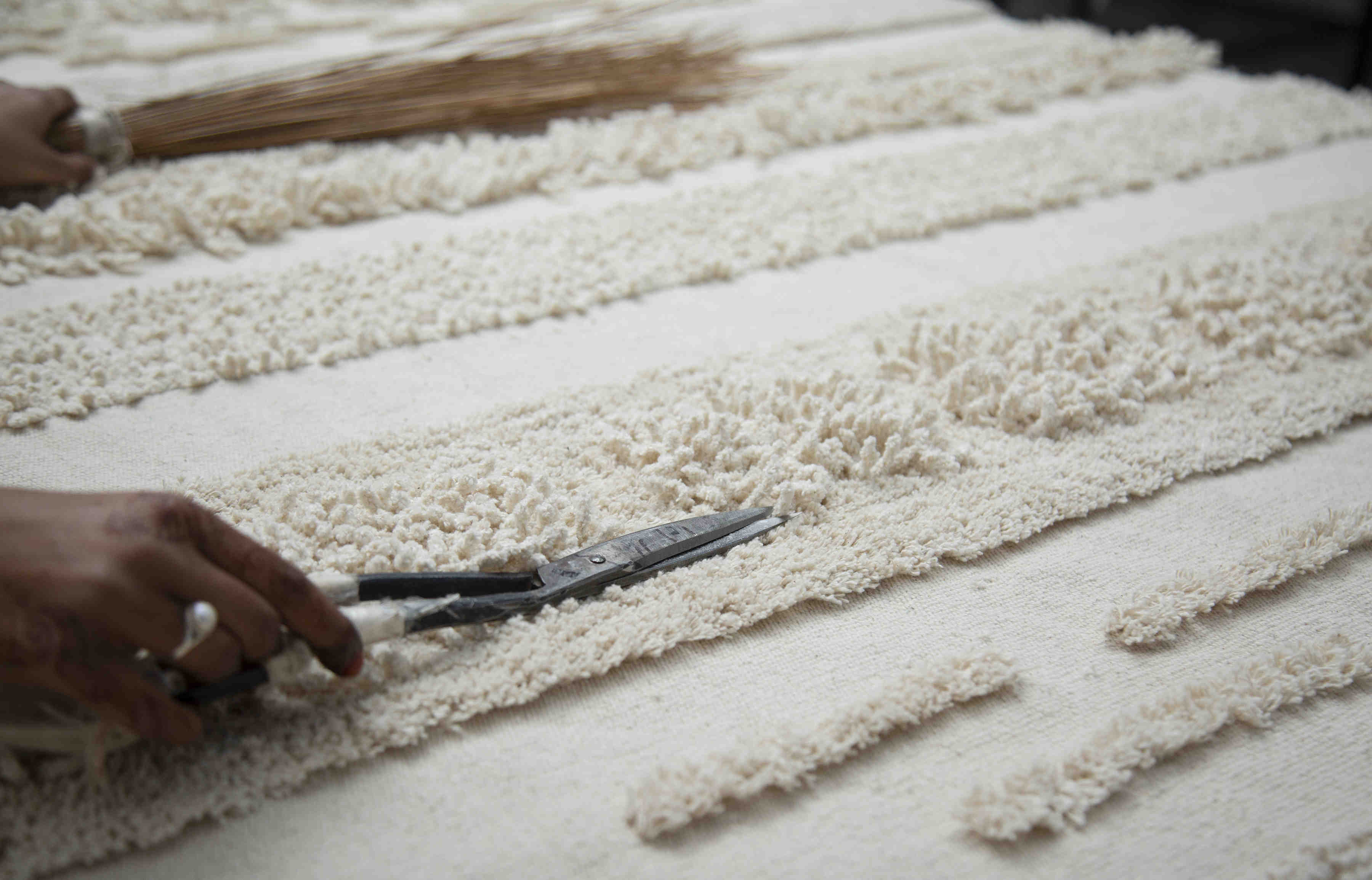 Rectangular natural beige rug decorated with a raised textured stripe pattern