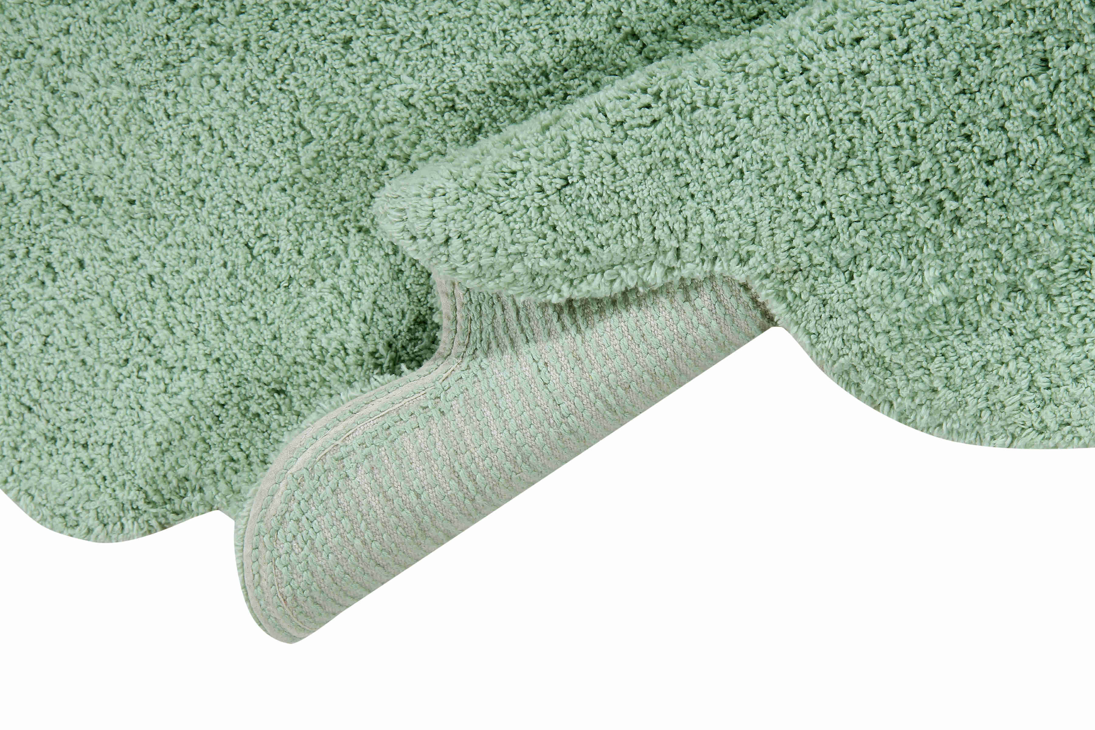 Circular green cotton rug with scalloped edge and detachable cream sheep cushion