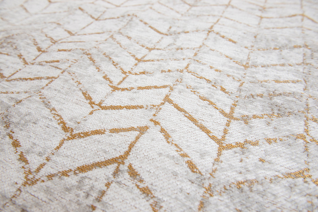 White flatweave rug with faded yellow chevron pattern