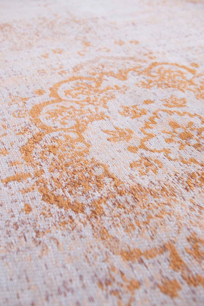 faded orange flatweave rug with traditional medallion design
