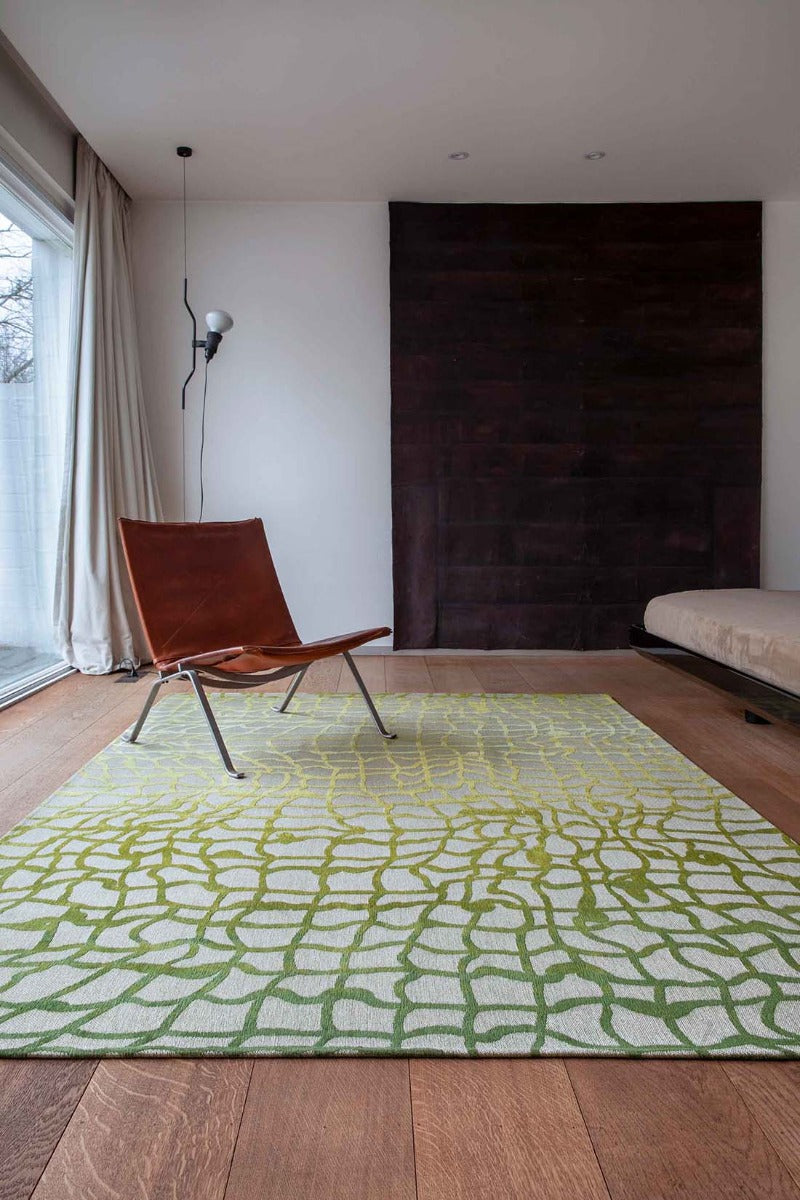 flatweave area rug with abstract green design
