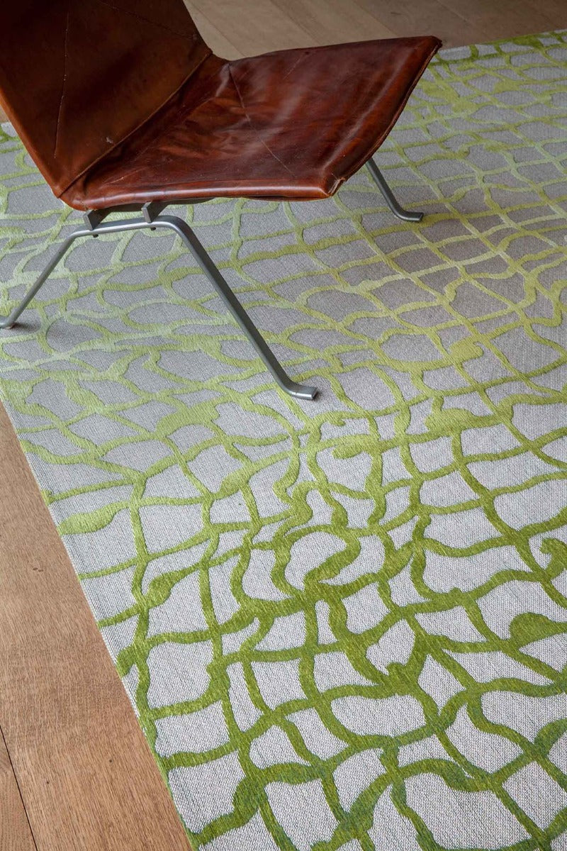 flatweave area rug with abstract green design
