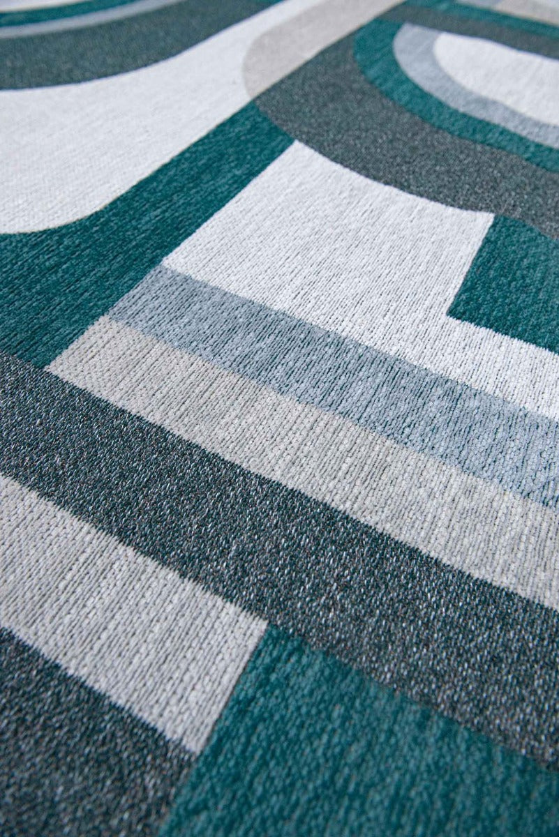 flatweave area rug with retro pattern in teal green and grey
