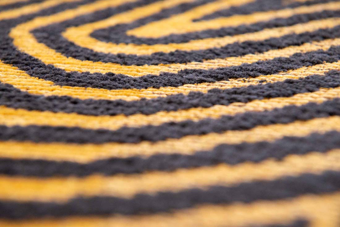 black and gold flatweave area rug with organic