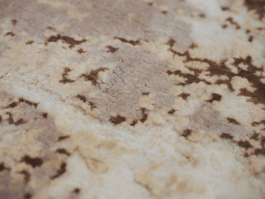 grey and taupe rug with an abstract damask pattern