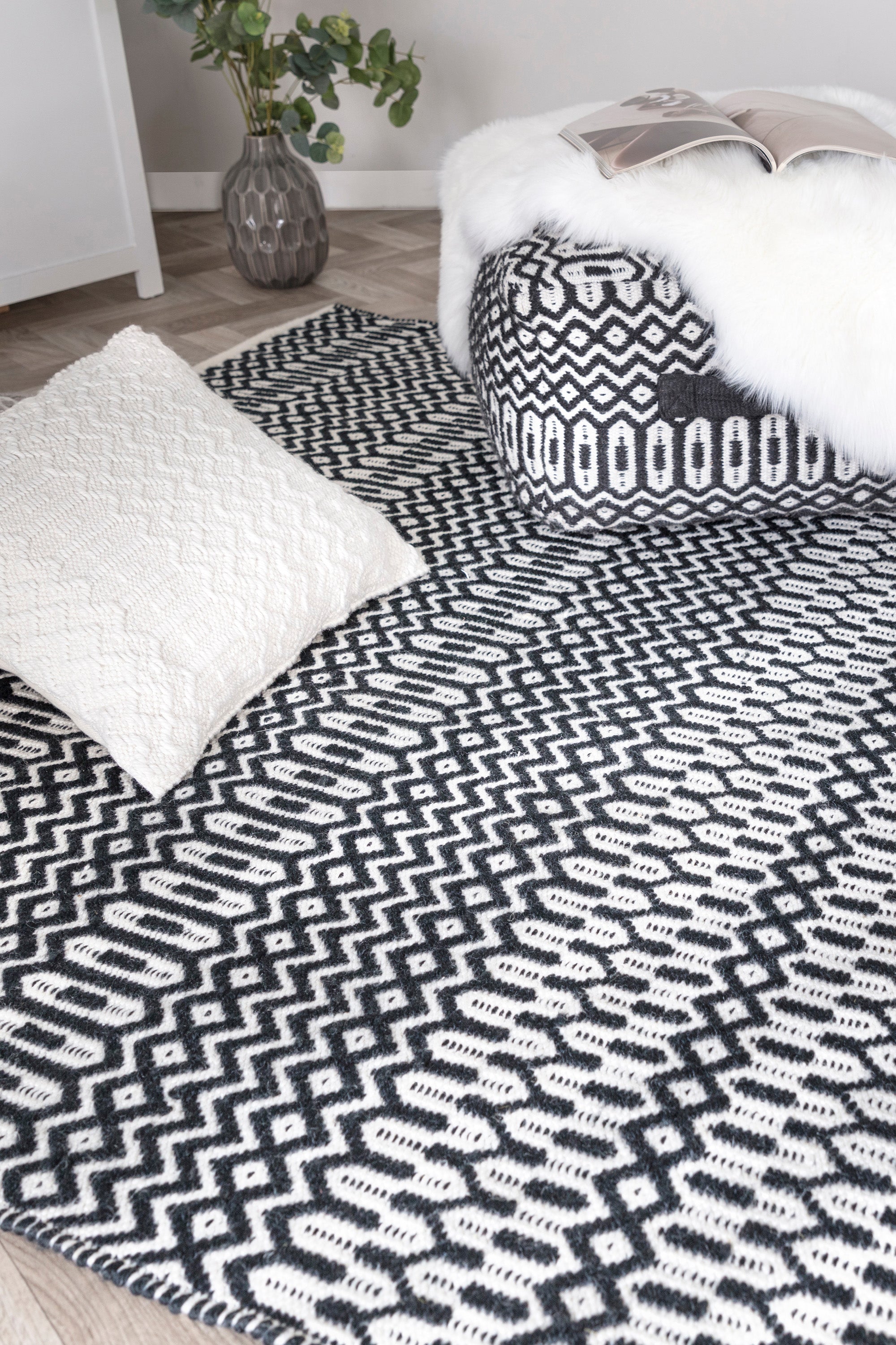 black indoor/outdoor rug with geometric design