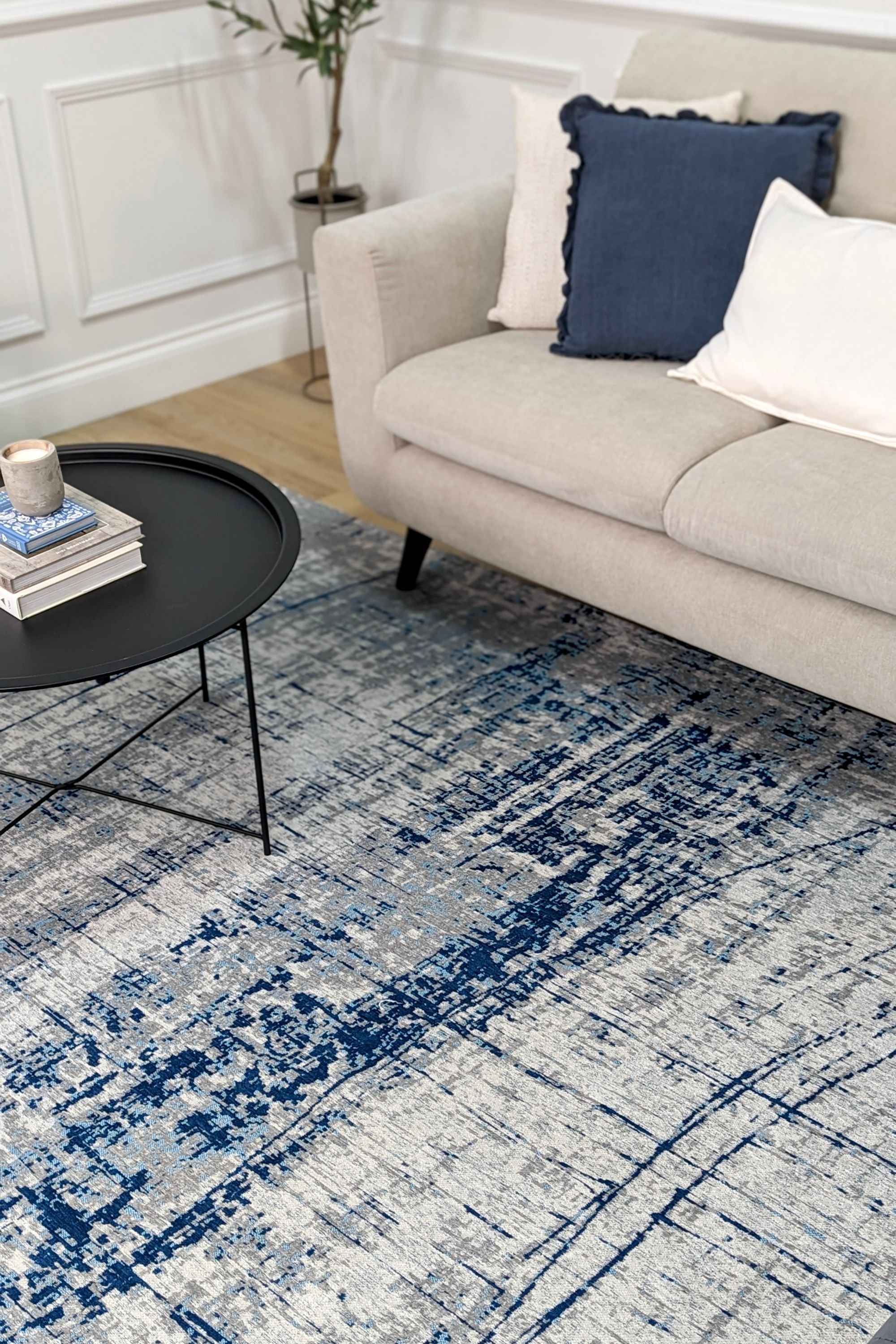 White flatweave rug with grey and blue abstract pattern