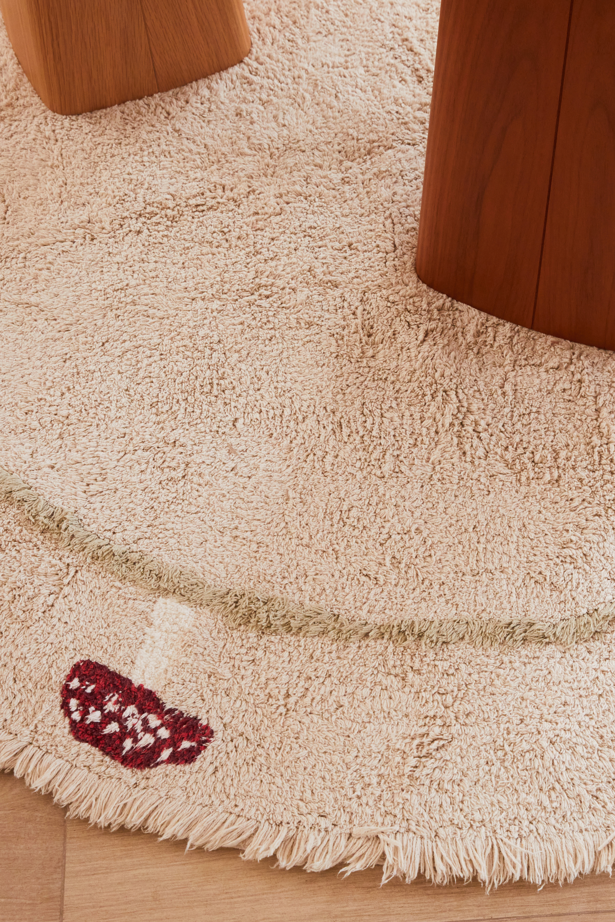 Round cream children's rug with mushroom border pattern