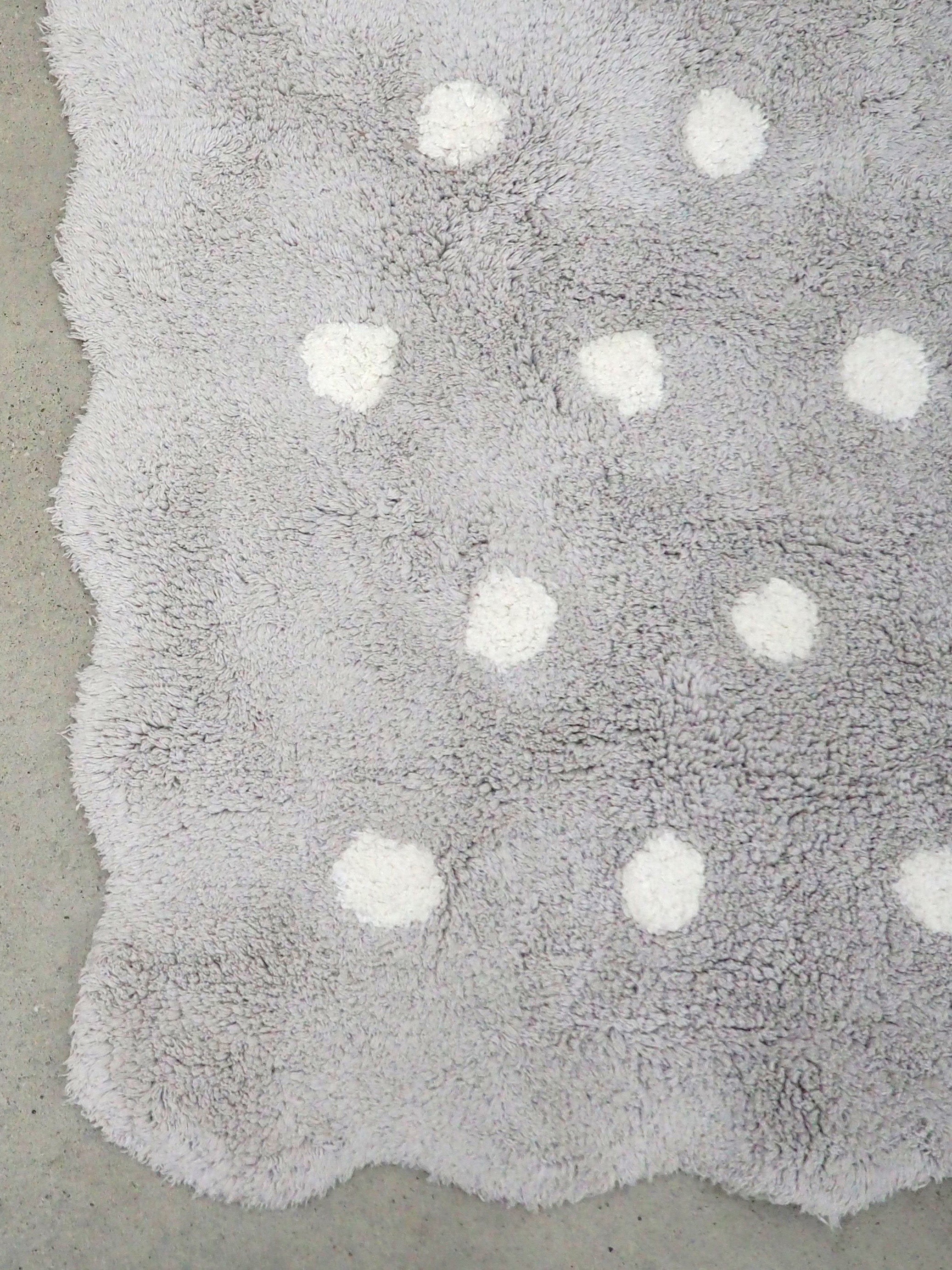 Grey children's rug with white polka dot pattern