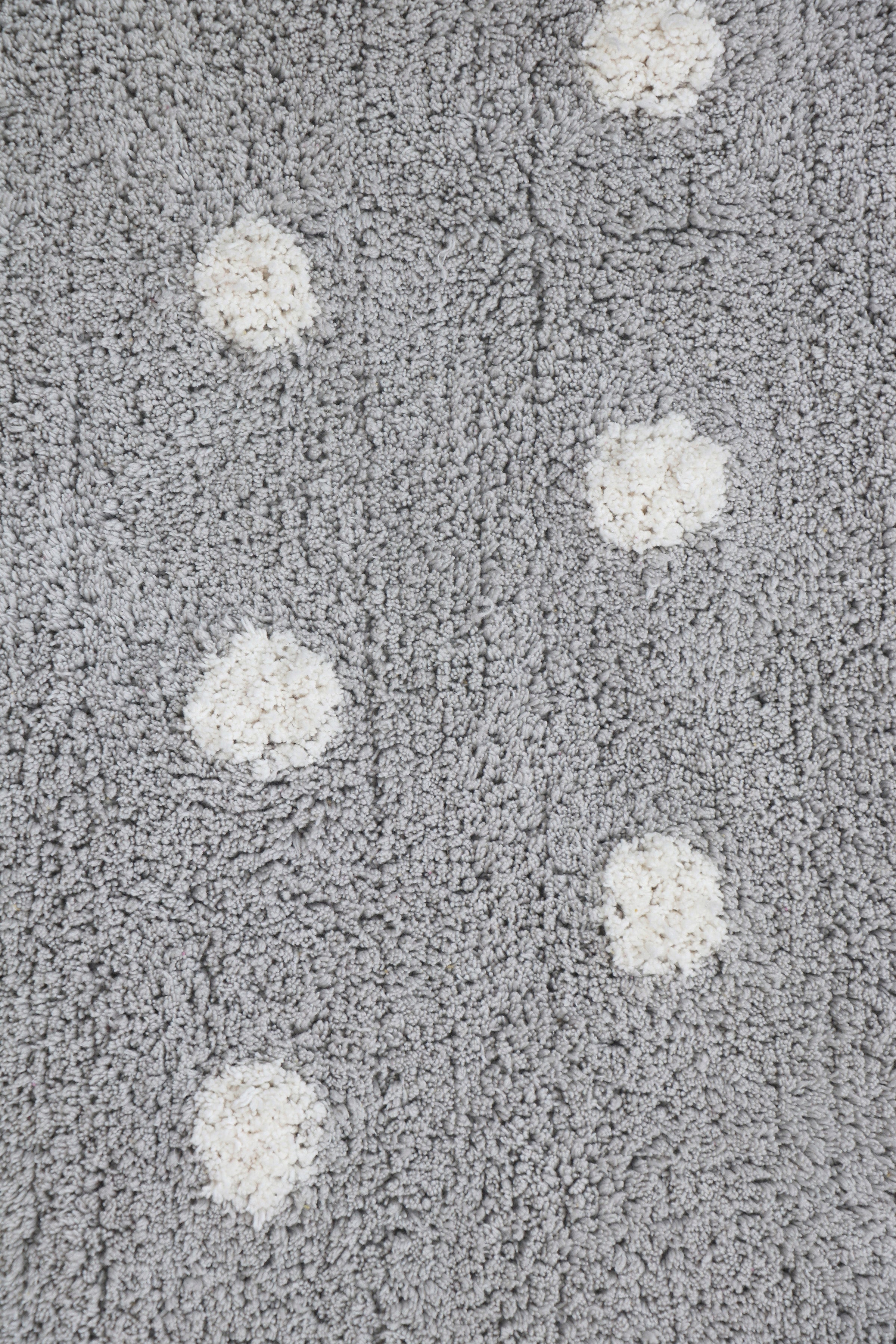 Grey children's rug with white polka dot pattern