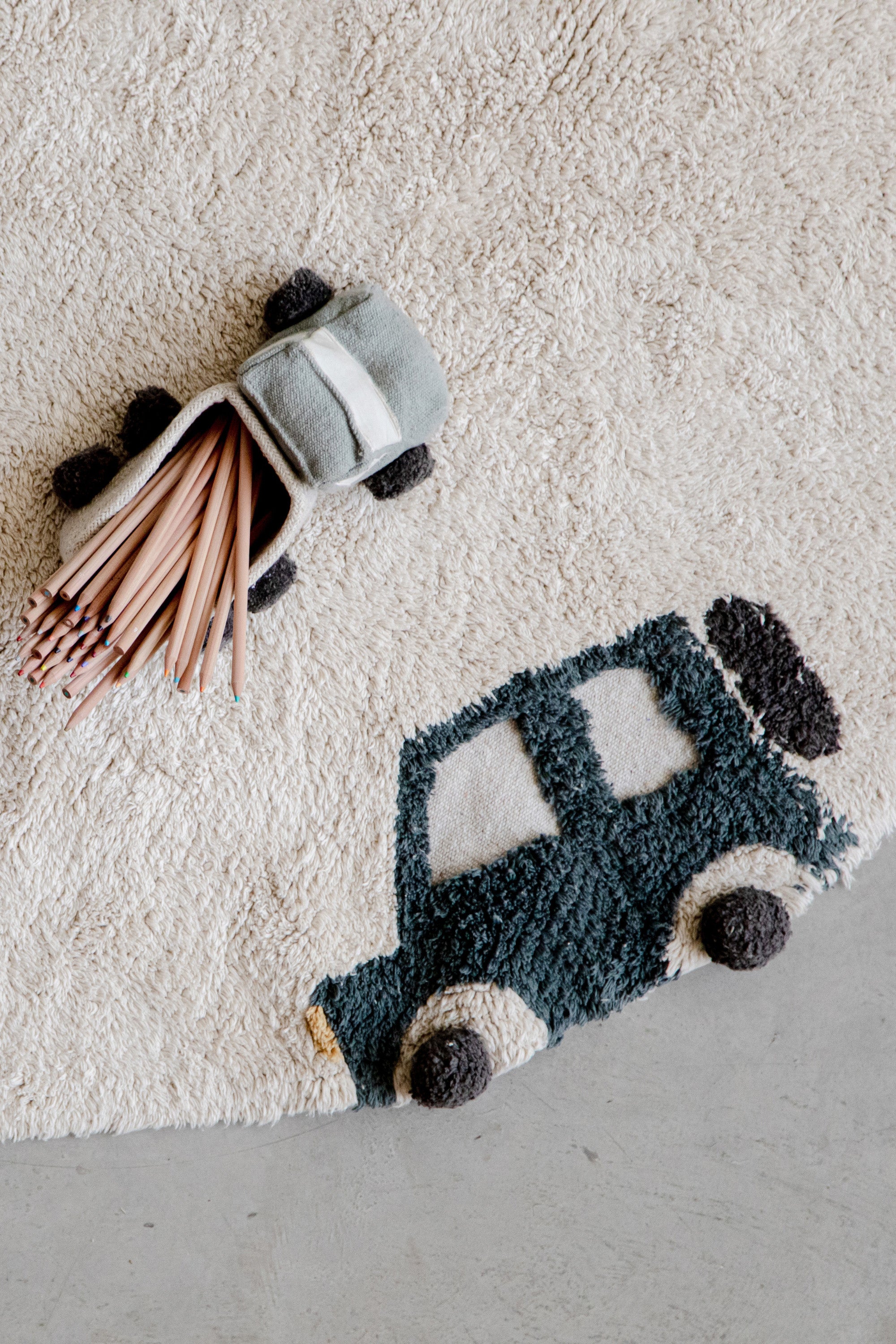 Round cream childs rug with vehicle motifs
