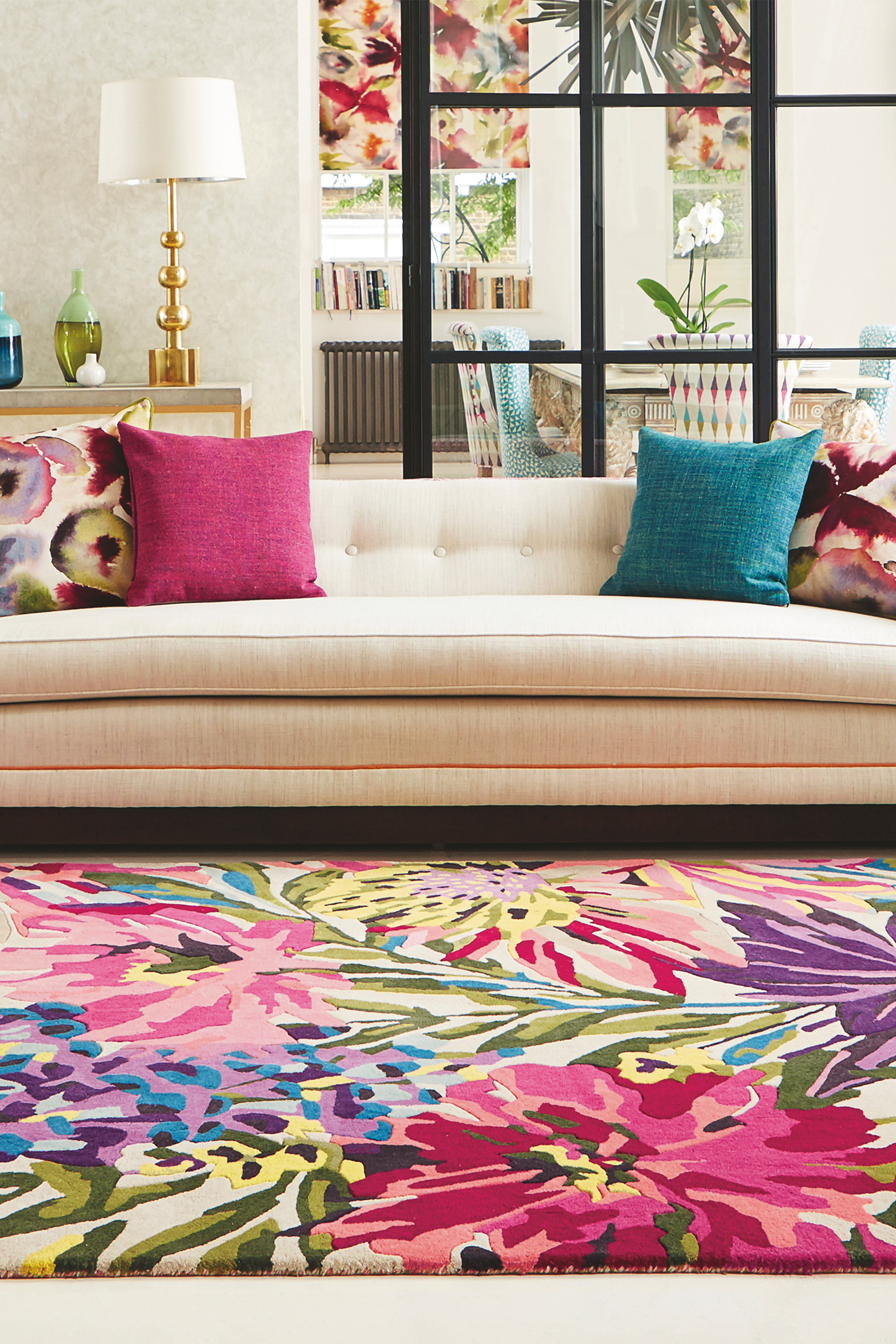 Rectangular white wool rug with pink, yellow, purple and green flowers and leaves