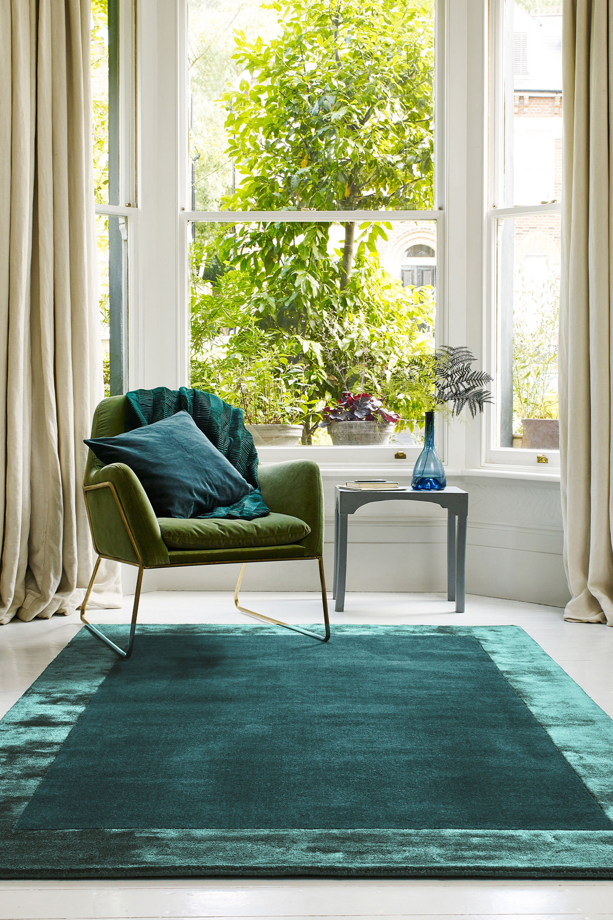 blue wool and viscose rug with a border design