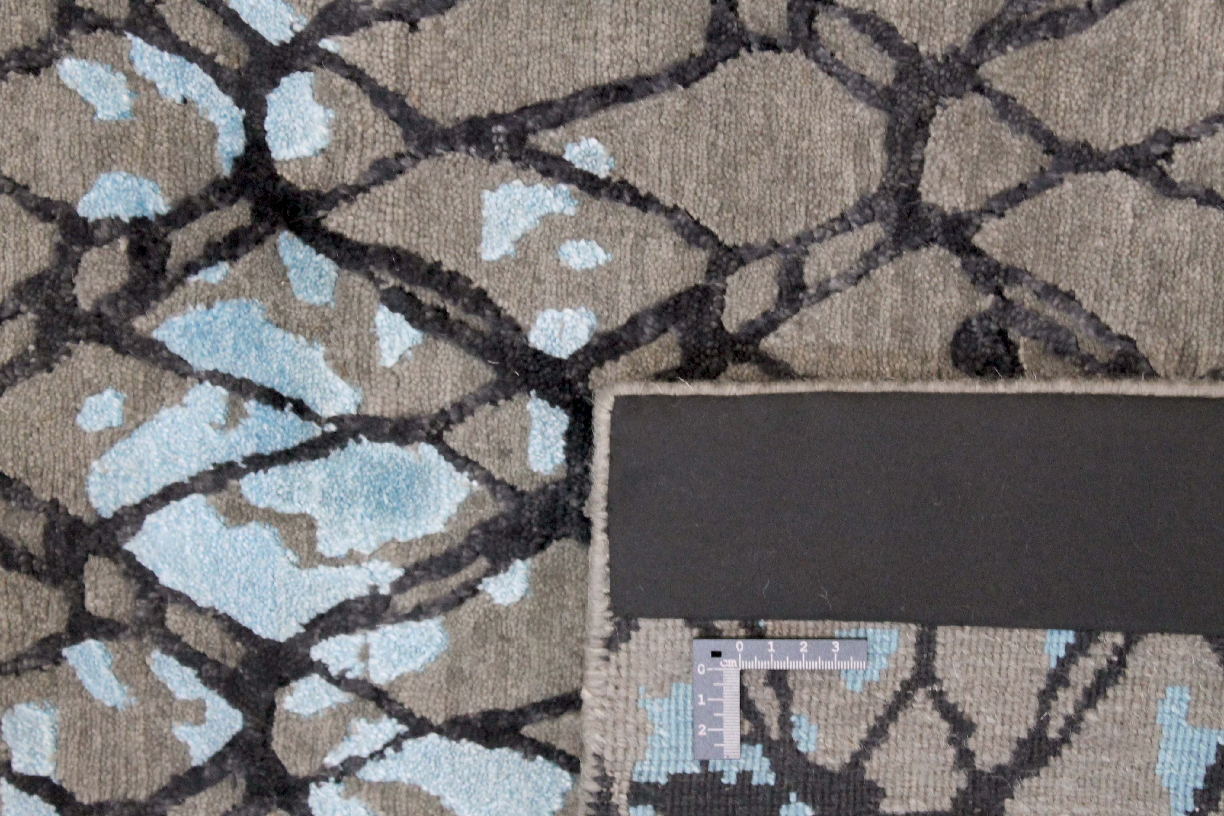Area rug with abstract design in blue