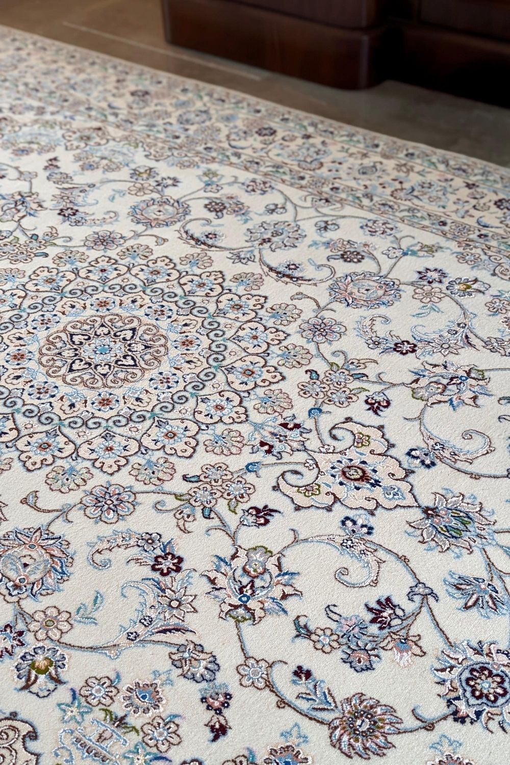 Authentic oriental rug with traditional floral design in cream, ivory and blue