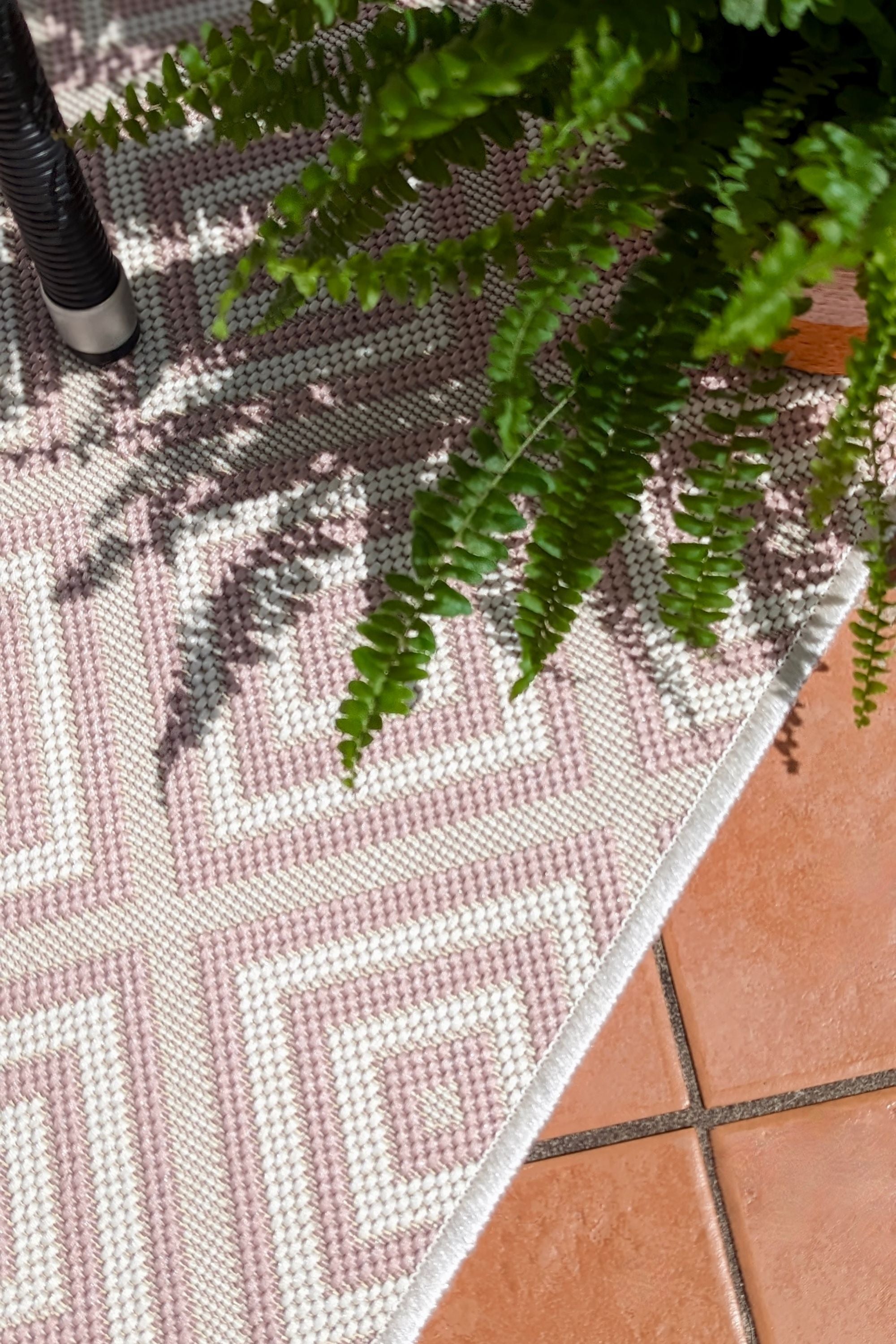 pink and white geometric rug for indoors and outdoors