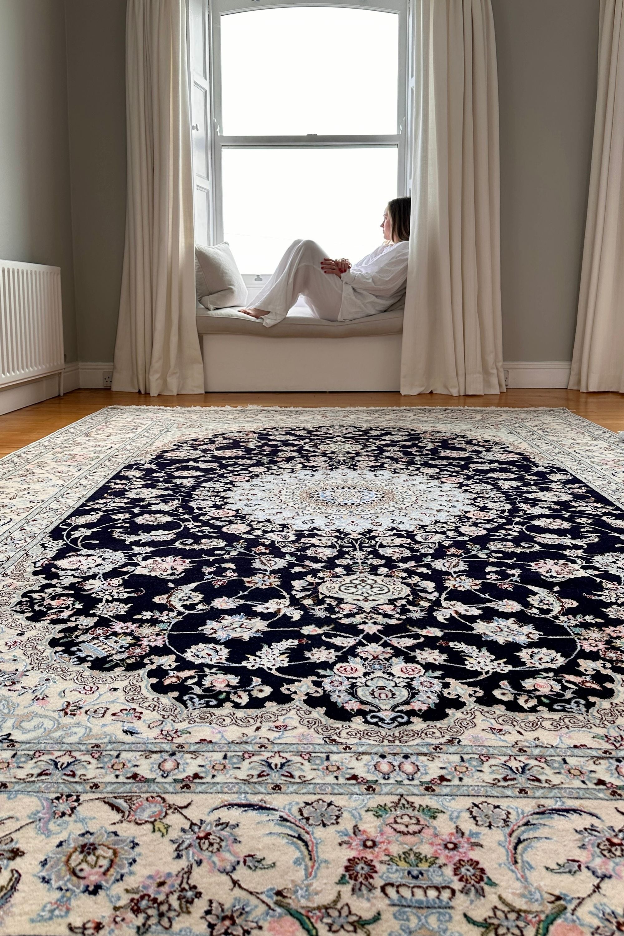 Authentic oriental rug with traditional floral design in cream, navy,  blue and pink