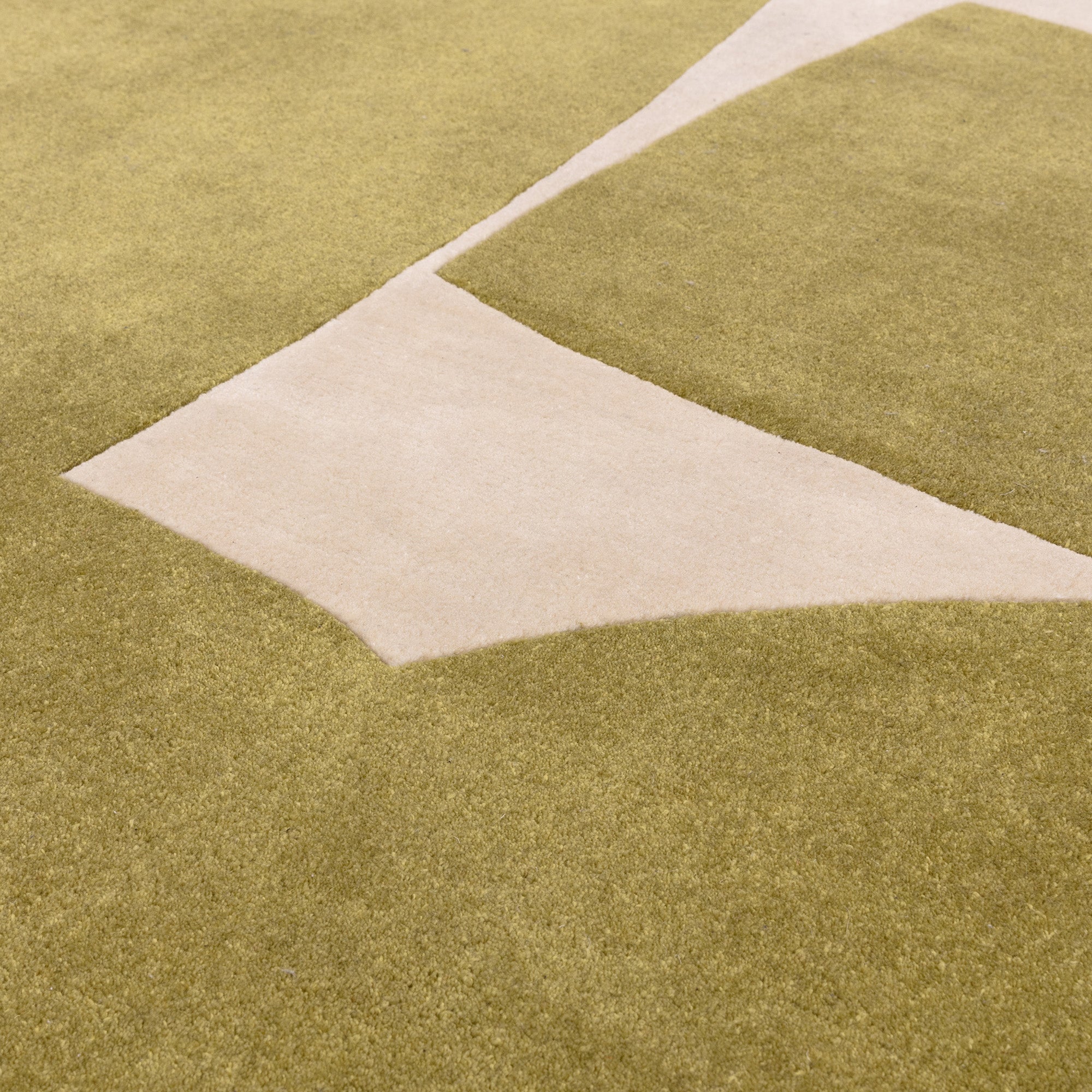 Sage green and cream rug with abstract pattern