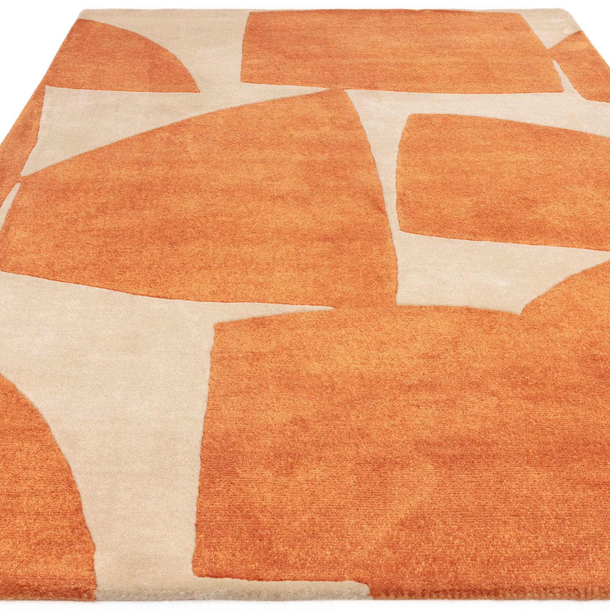 Orange and cream rug with abstract pattern