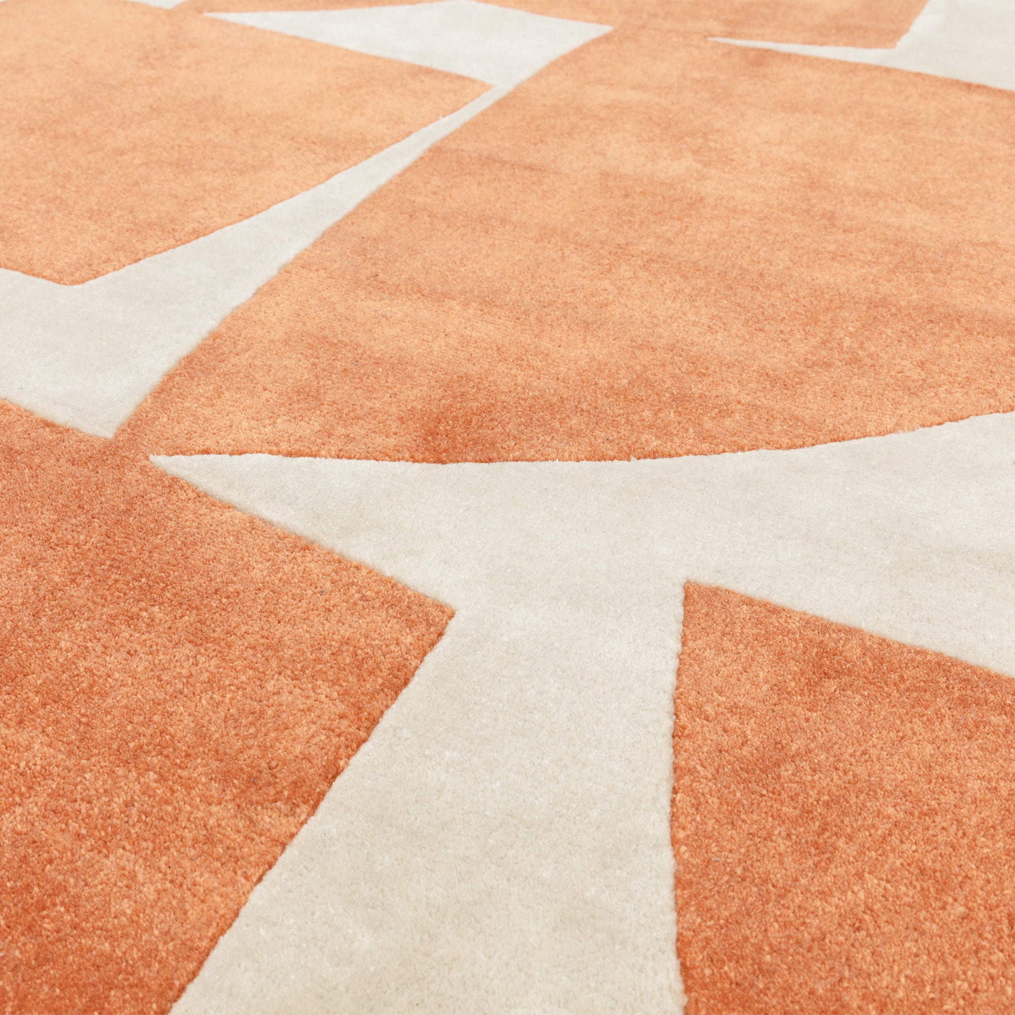 Orange and cream rug with abstract pattern