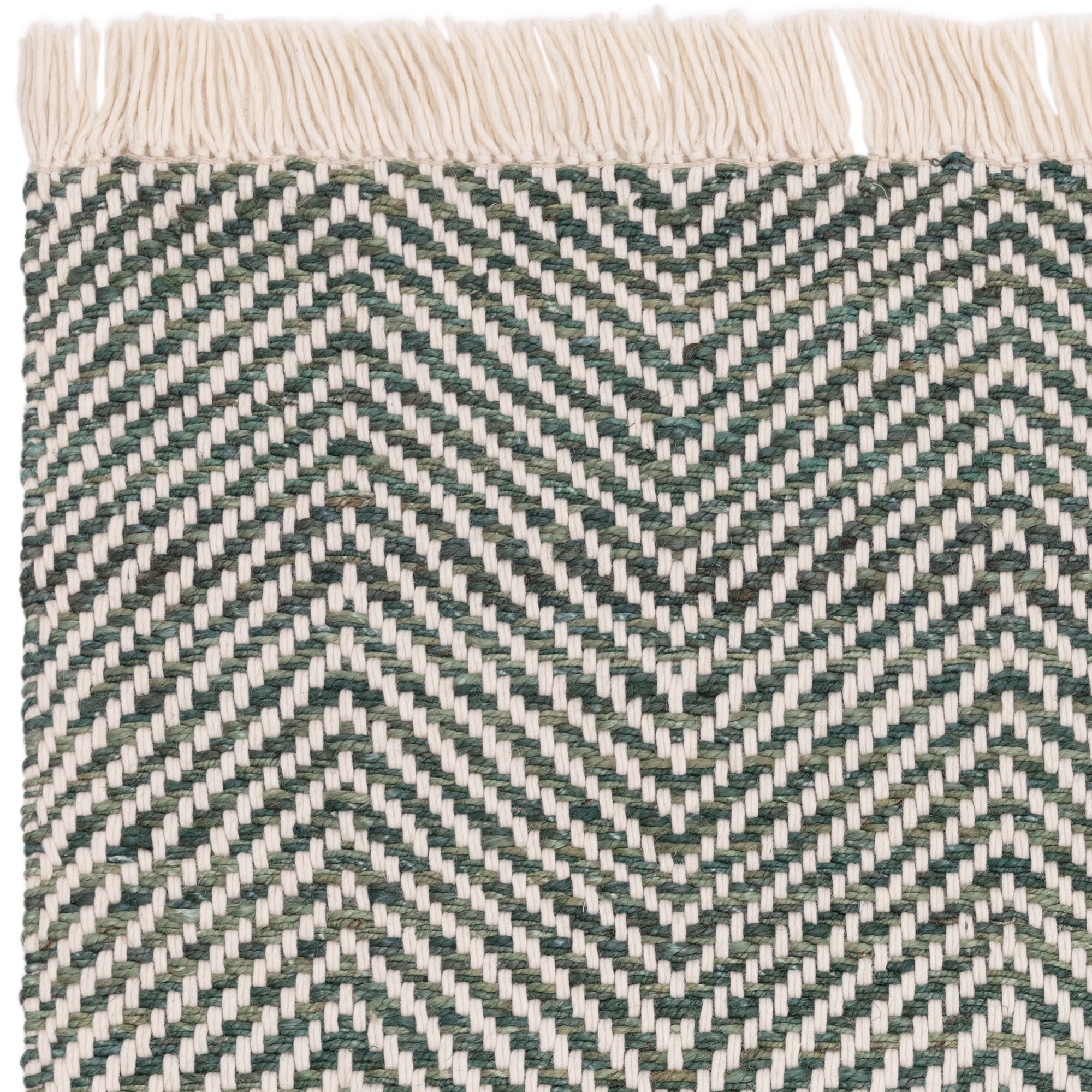 Textured woven rug with green and cream chevron pattern