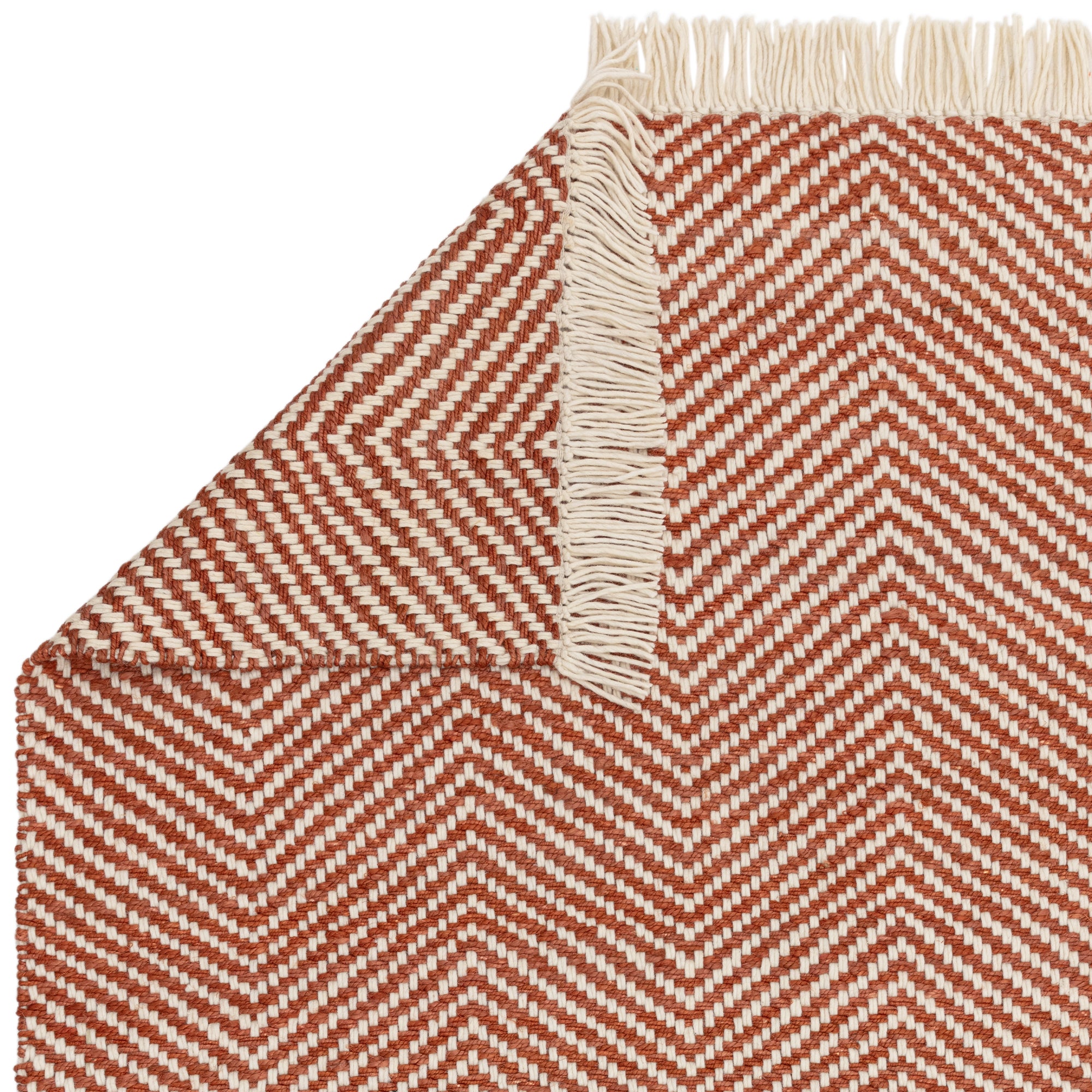 Textured woven rug with red and cream chevron pattern
