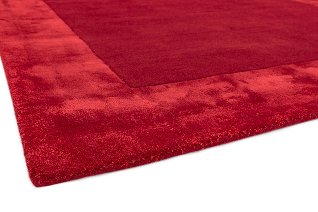 red wool and viscose rug with a border design
