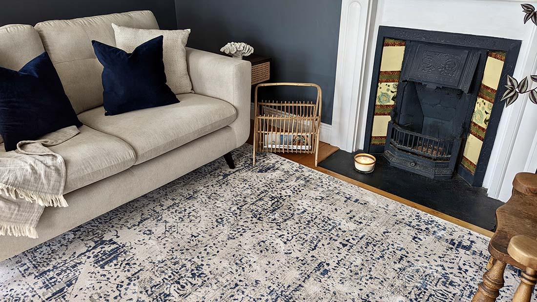 grey Persian style area rug with navy detail