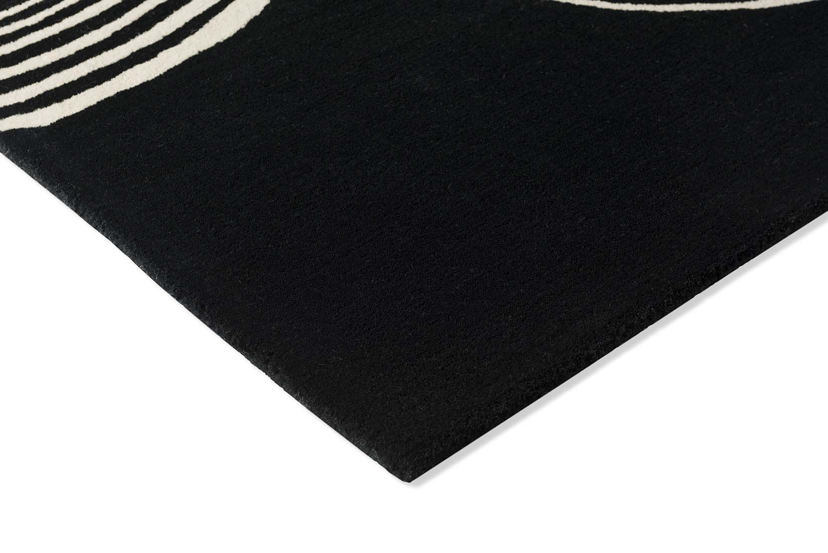 black rug with cream brush strokes 
