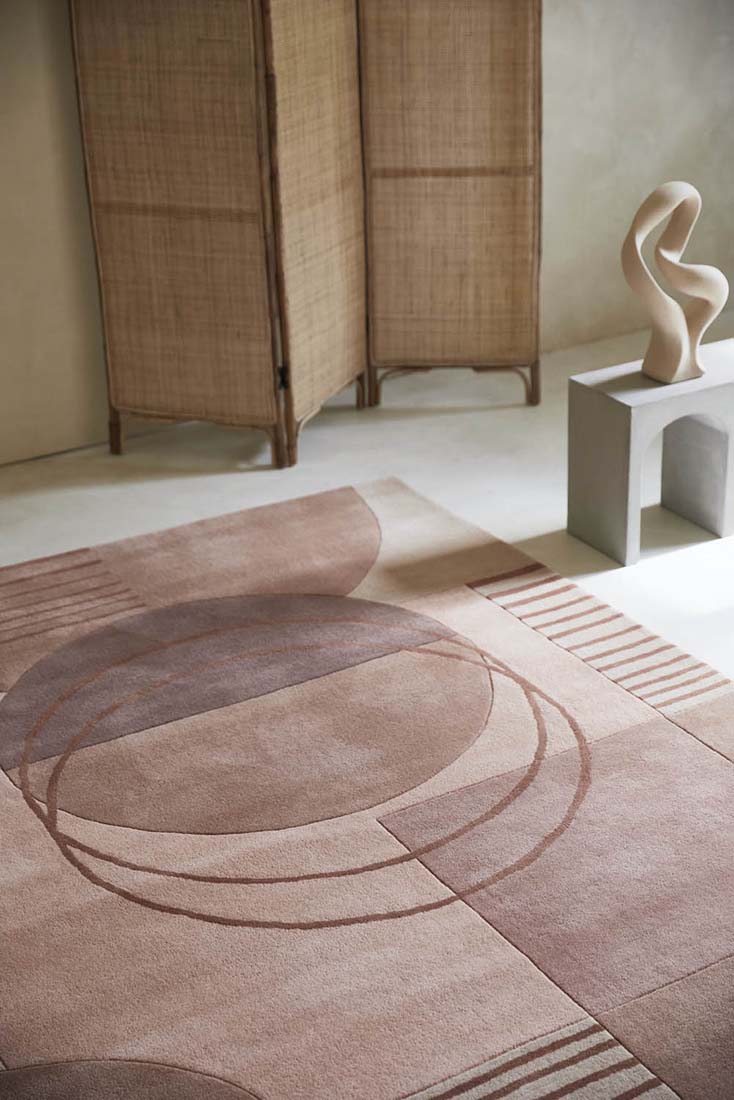 pink wool area rug with modern geometric design 
