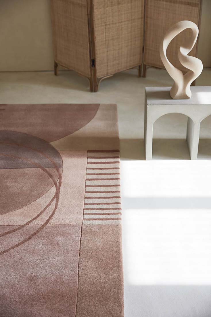 pink wool area rug with modern geometric design 
