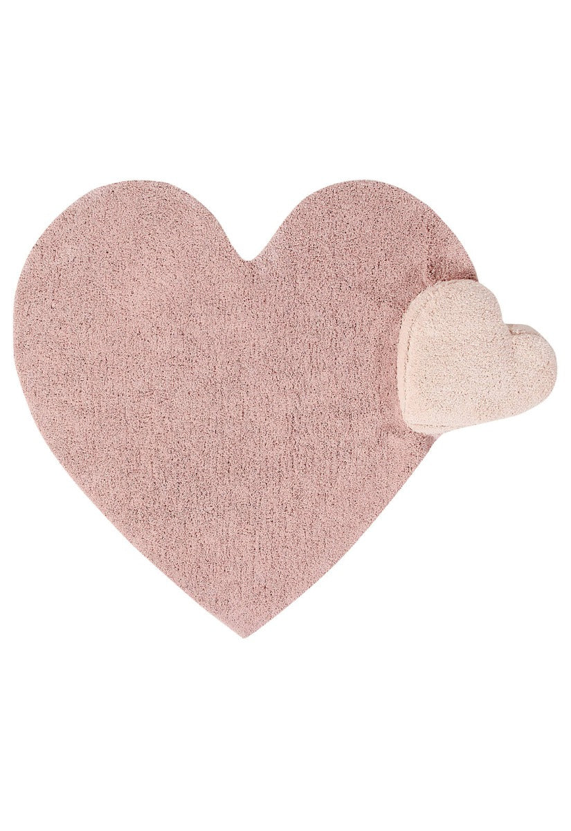 A large pink cotton rug shaped like a heart, with a smaller detachable nude heart cushion