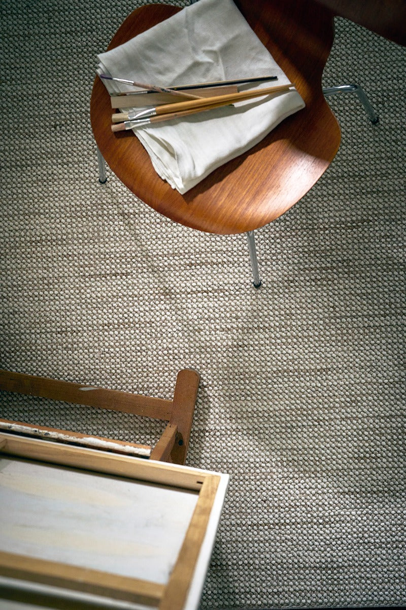 Textured area rug in stone and beige hues 
