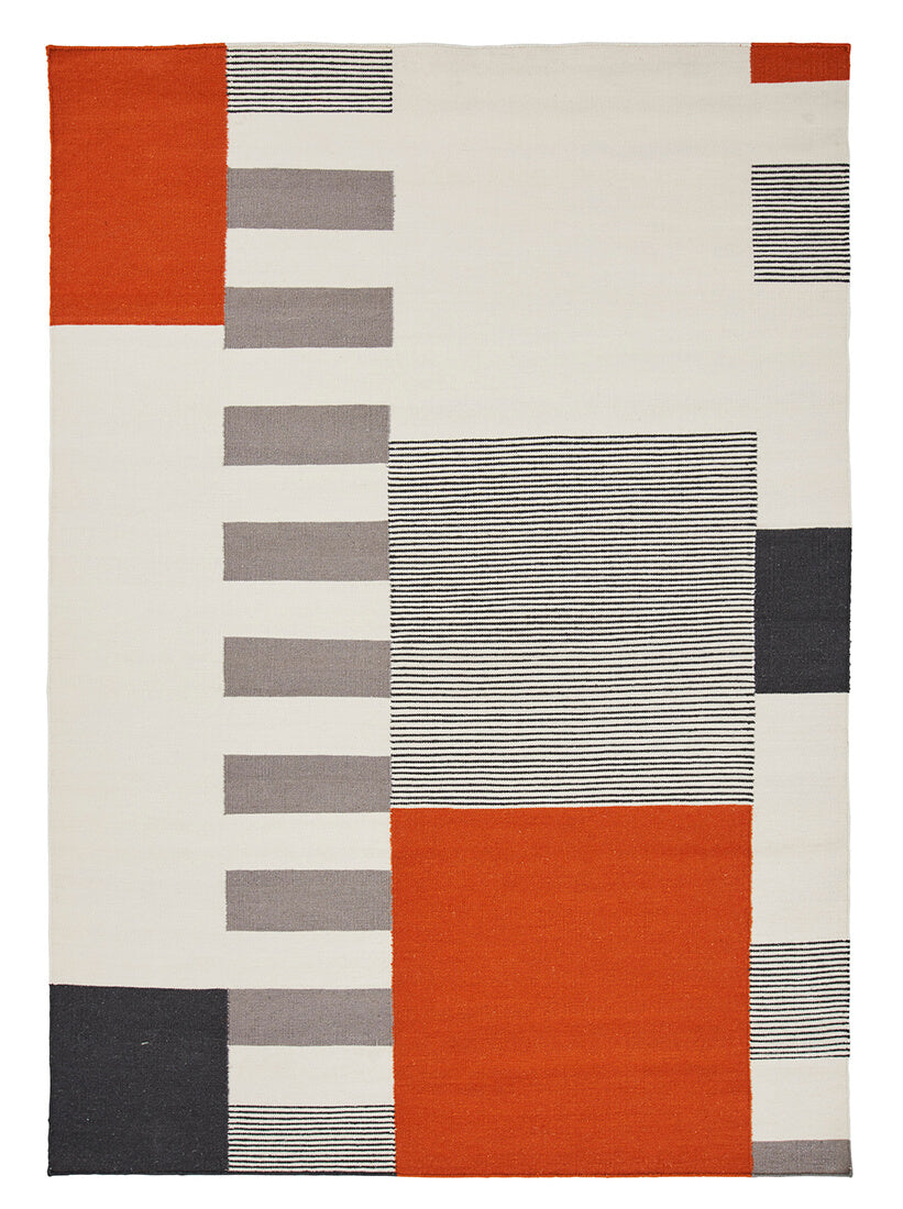 geometric wool rug with orange design
