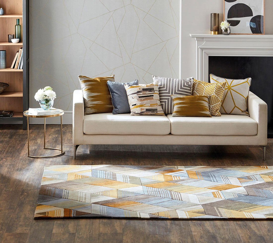 Harlequin rug with a multi-directional stripe design in grey and mustard yellow