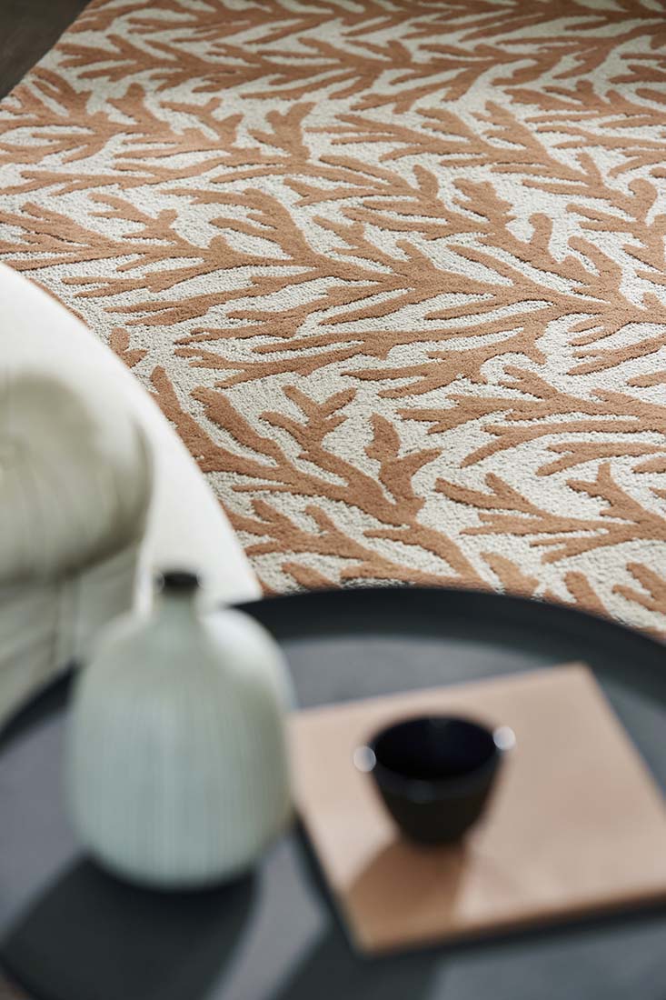 copper and cream wool rug in a coral motif
