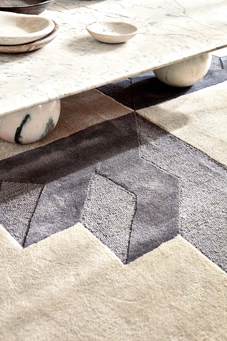Geometric rug in shades of beige, grey, and navy