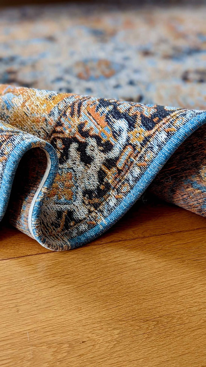 Orange flatweave rug with persian design and blue details