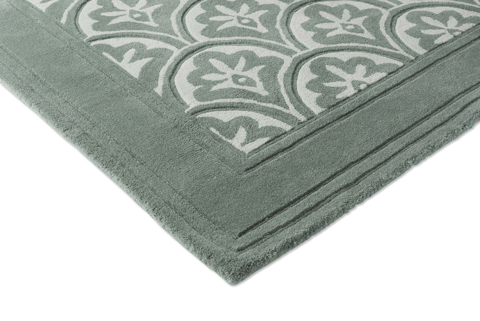 Modern dark green wool rug with leaf motif 
