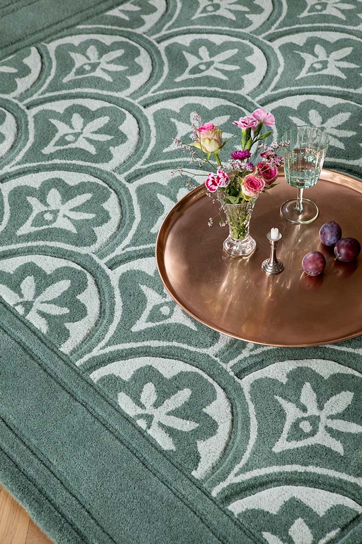 Modern dark green wool rug with leaf motif 
