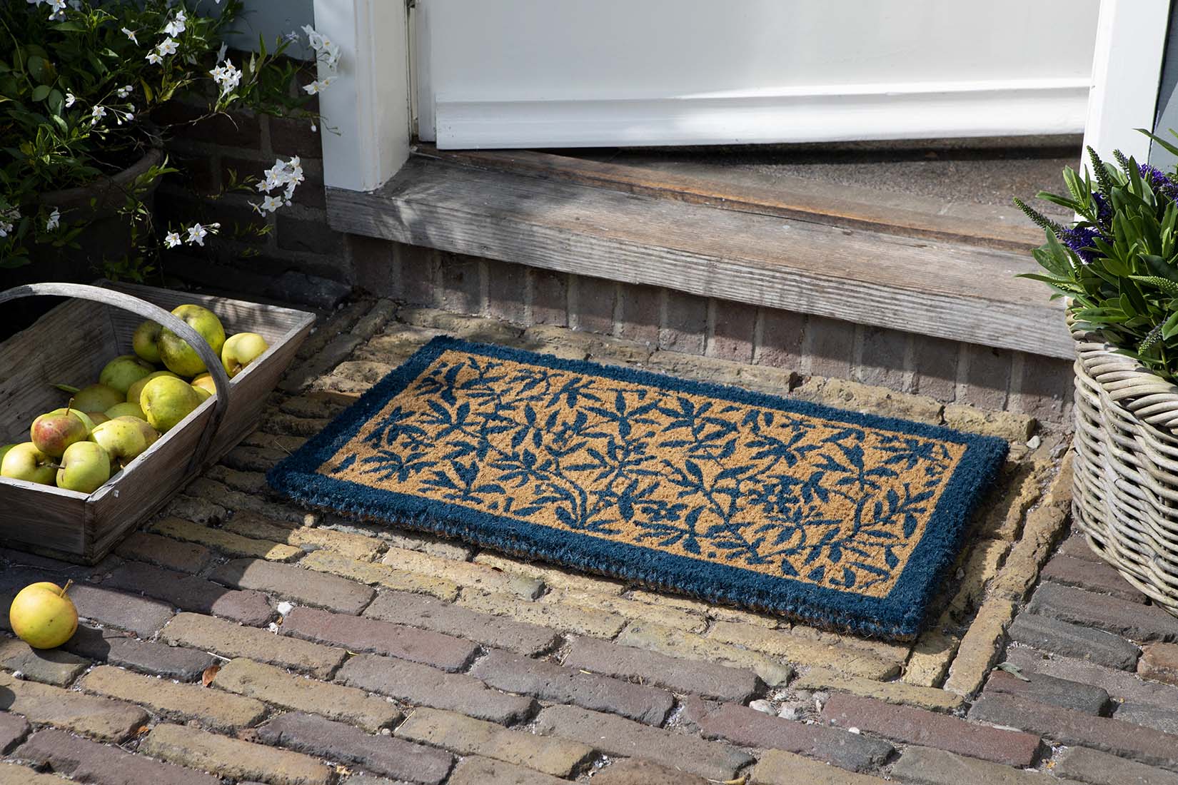 Coir doormat with blue floral pattern
