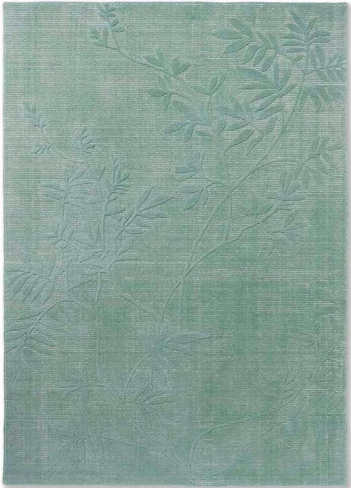Green wool rug with floral pattern
