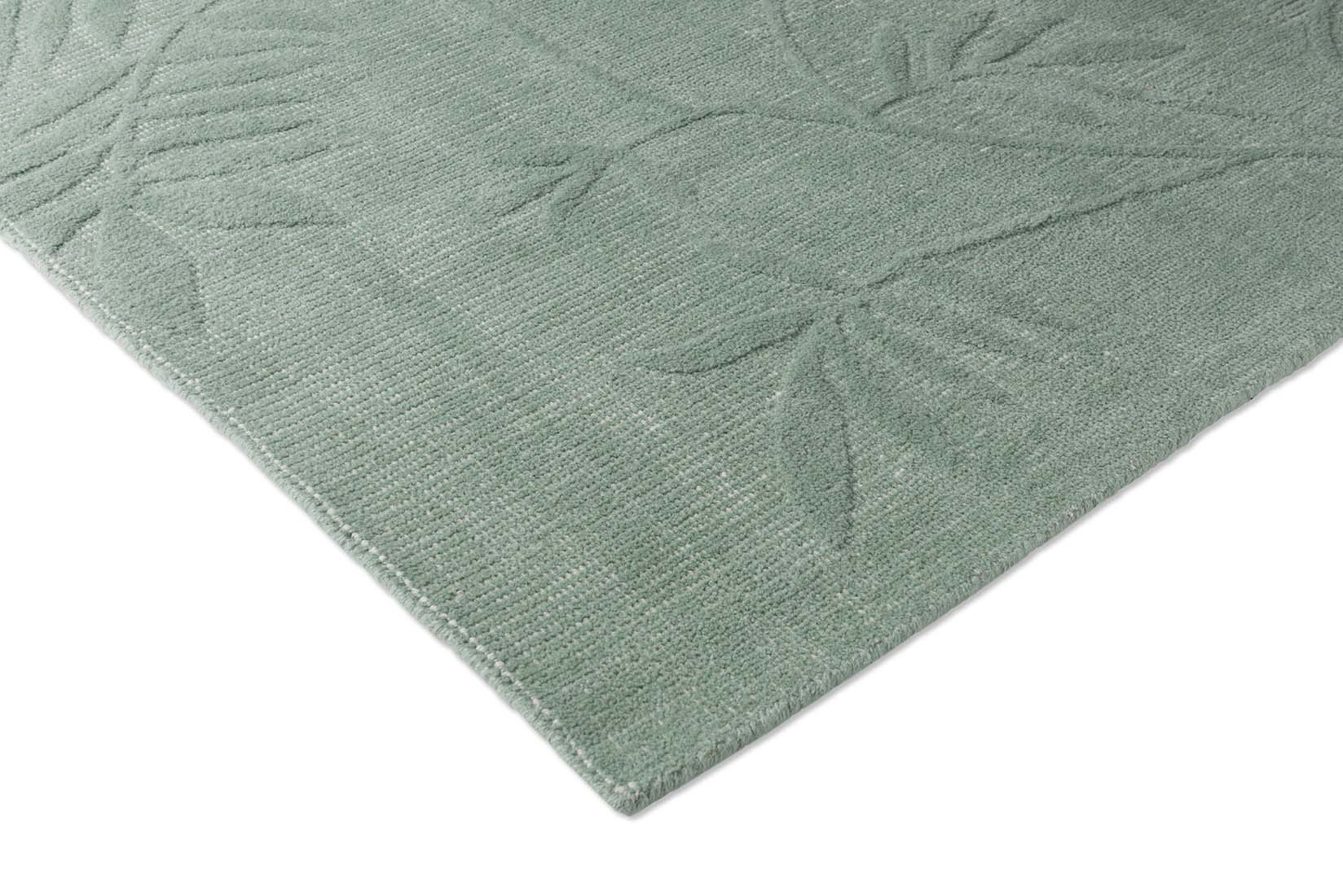 Green wool rug with floral pattern
