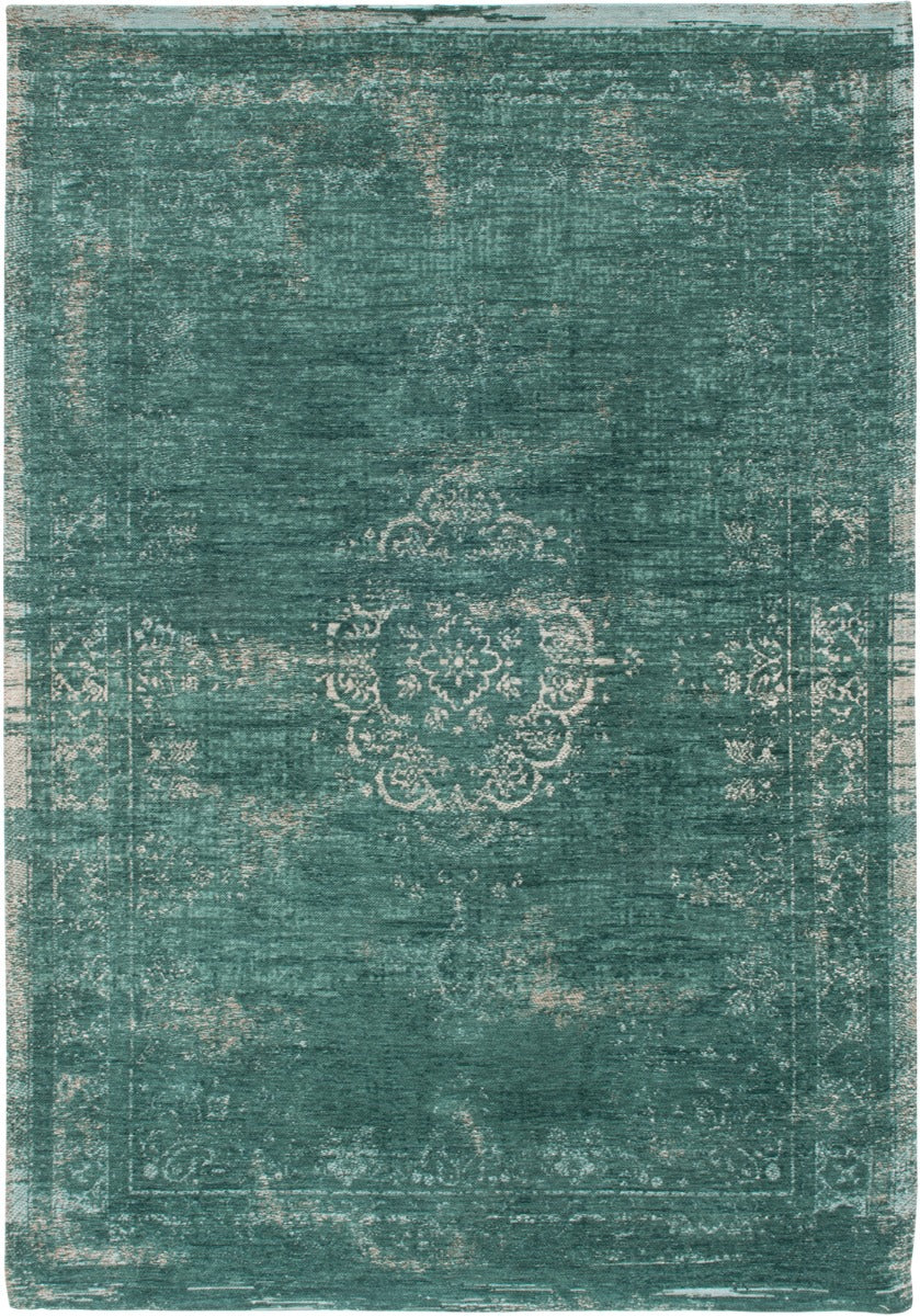 green flatweave rug with faded persian design