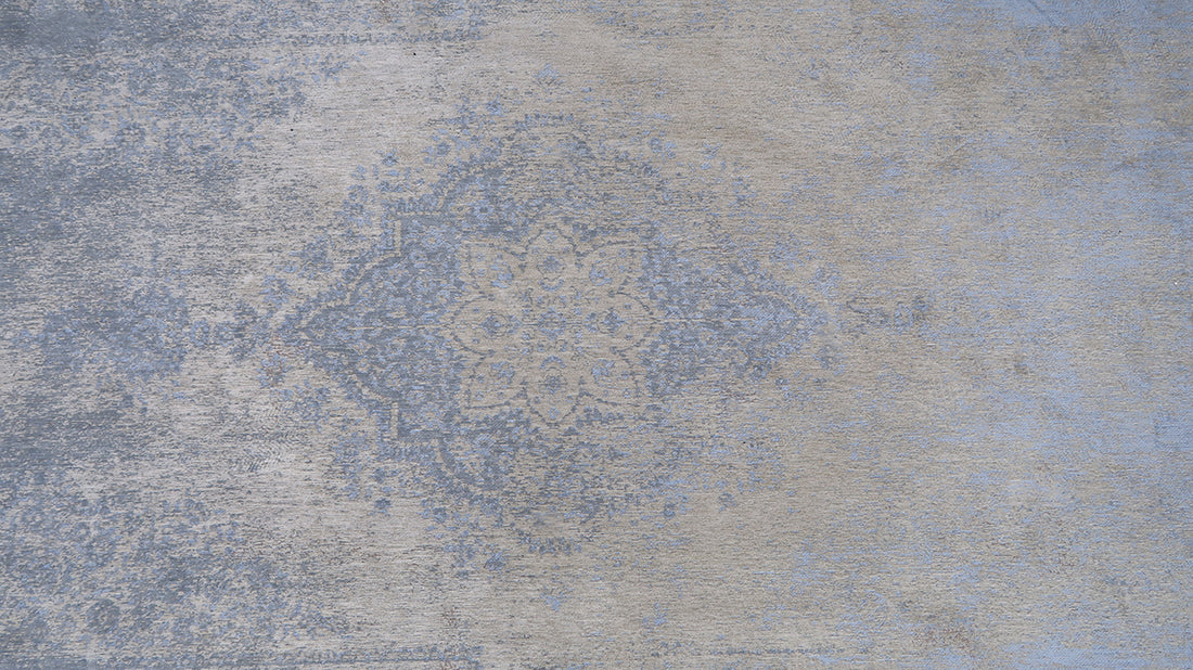 Blue and beige flatweave rug with faded persian medallion pattern