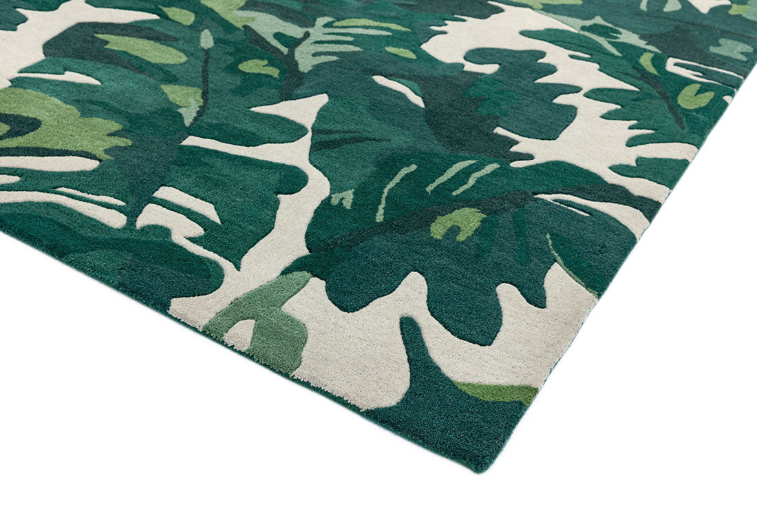area rug with a green palm leaf design